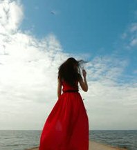 Woman in red dress on pier